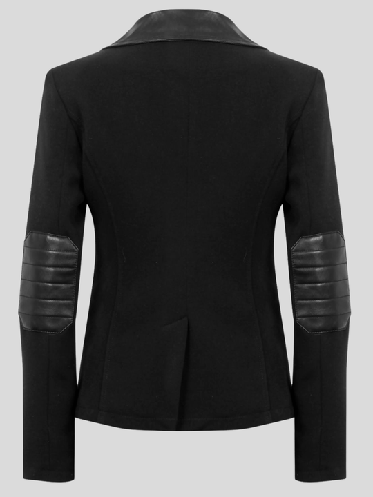 Ghost mannequin stands in front of a grey background. The ghost mannequin wears a  single breasted black tailored blazer, with faux leather lapel and single front button fasten. The ghost mannequin stands with their back to the camera, the tailored back and the faux leather cuff elbows can be seen.