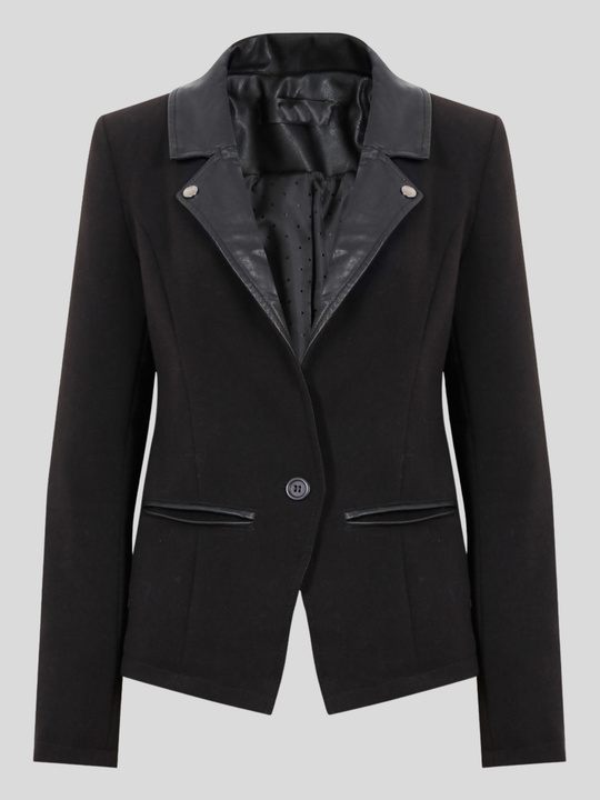 Ghost mannequin stands in front of a grey background. The ghost mannequin wears a  single breasted black tailored blazer, with faux leather lapel and single front button fasten. The ghost mannequin stands in front of the blazer, the front of the blazer can be seen. 