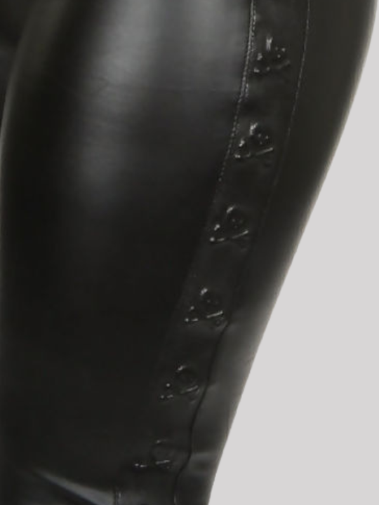 Close up. Black faux leather wet look leggings, with a skull embossed side panel. 