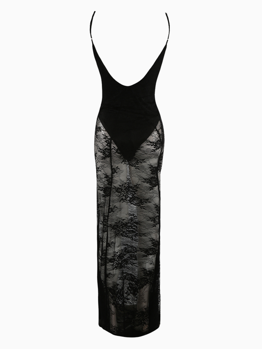 Full length shot. Ghost mannequin stands in front of a plain background. The  ghost mannequin wears a sheer black lace maxi dress, with black bodysuit insert, v neckline and spaghetti straps. The gosy mannequin stands with their back to the camera, the back of the dress can be seen.