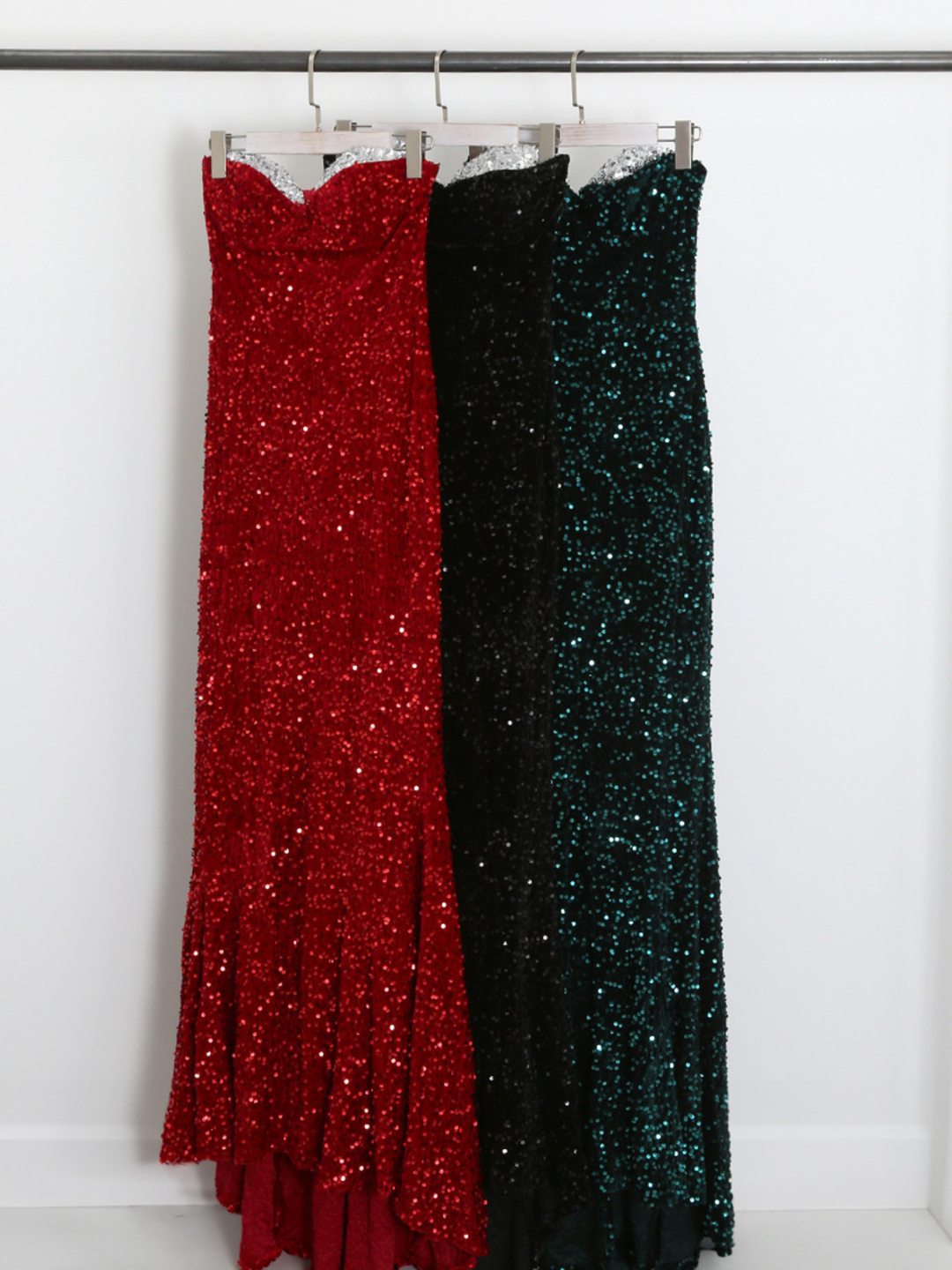 Clothing rack demonstrating long sequin maxi  dress with a sequin neckline on a clothing rail.