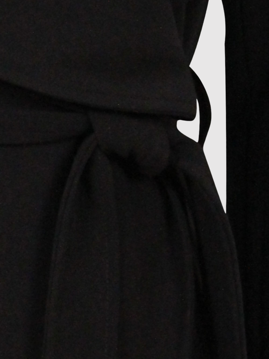 Close up of the belt on a black wrap coat.