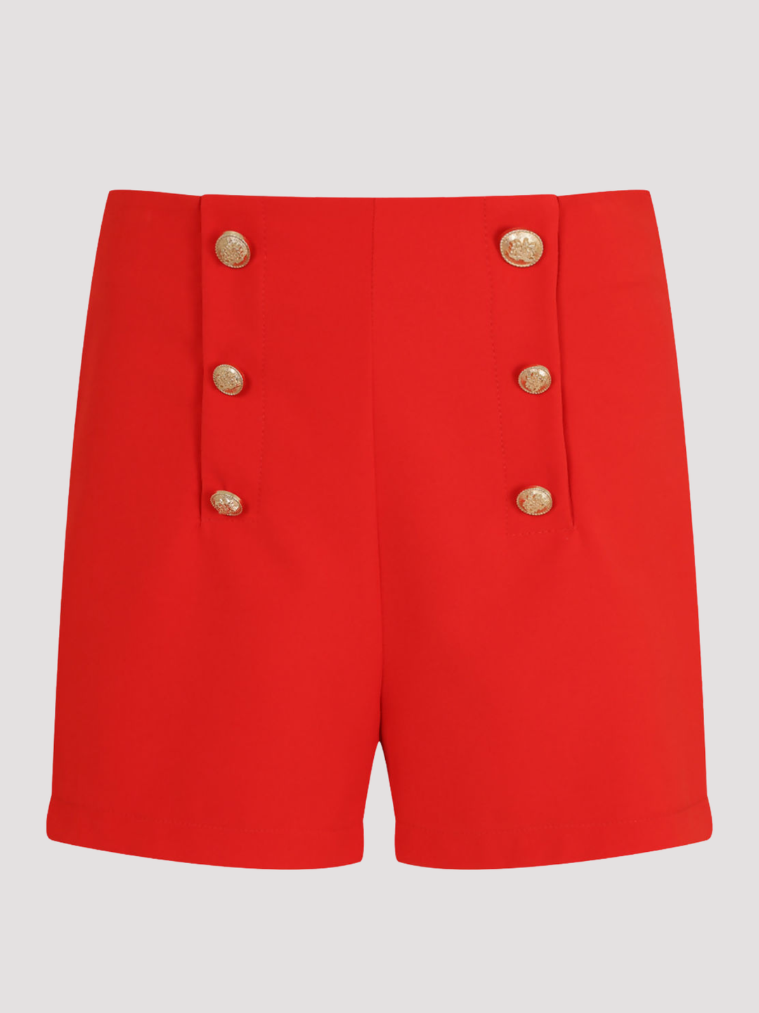Ghost manequin stands in front of a plain background. The ghost mannequin wears a tailored red shorts, with front gold button trim. The ghost mannequin faces forward, the front of the gold button can be seen. 