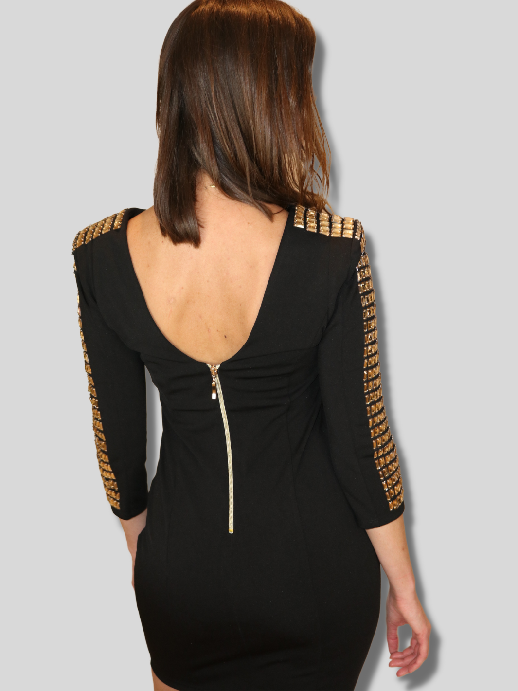 4ever Stunning Deluxe Premium black midi dress with gold rhinestone jeweled arms and chunky gold back zip fastening. model has her back to the camera, the plunging back is fastened by a chunky gold exposed zip. 