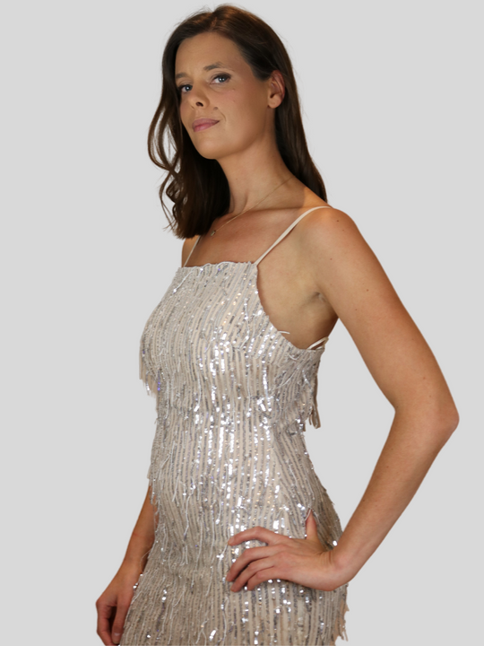 Model wears 4ever Stunning sequinned tassle dress with low back. Model stands to the side and places her hand on her hip. 