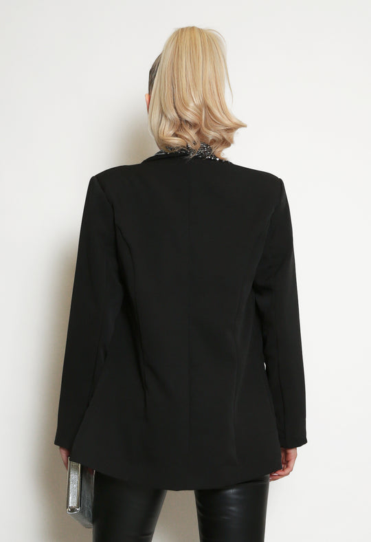 Deluxe Premium Range, Light Weight Black Blazer With Sequin Lapel Trim,  model has her back to the camera, the back of the blazer is visible and has a silver sequin trim at the neck which is visible.