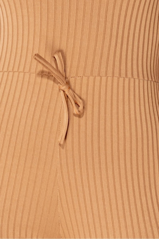 Close up of camel ribbed knit material 