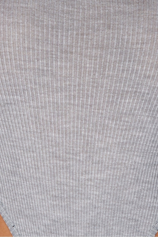 closeup of the grey ribbed material of the high legged grey bodysuit. 