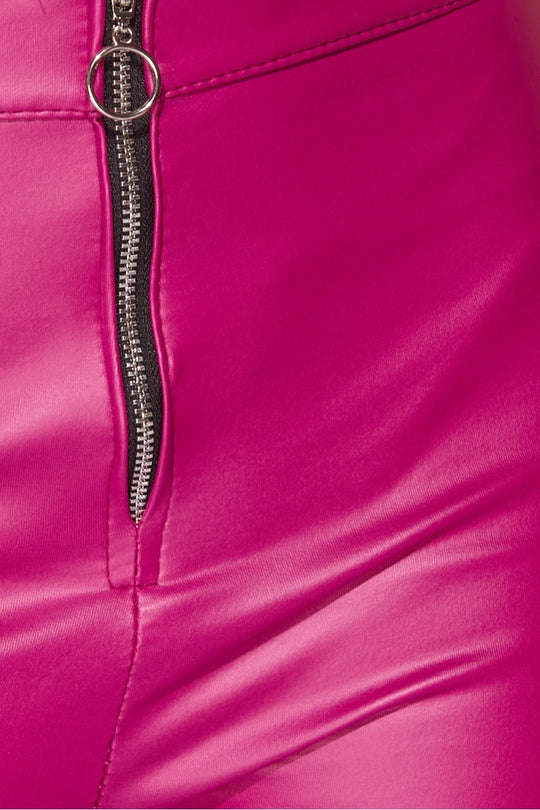 Closeup of the jegging's front zip fasteninng. The bright faux leather material is also visible.